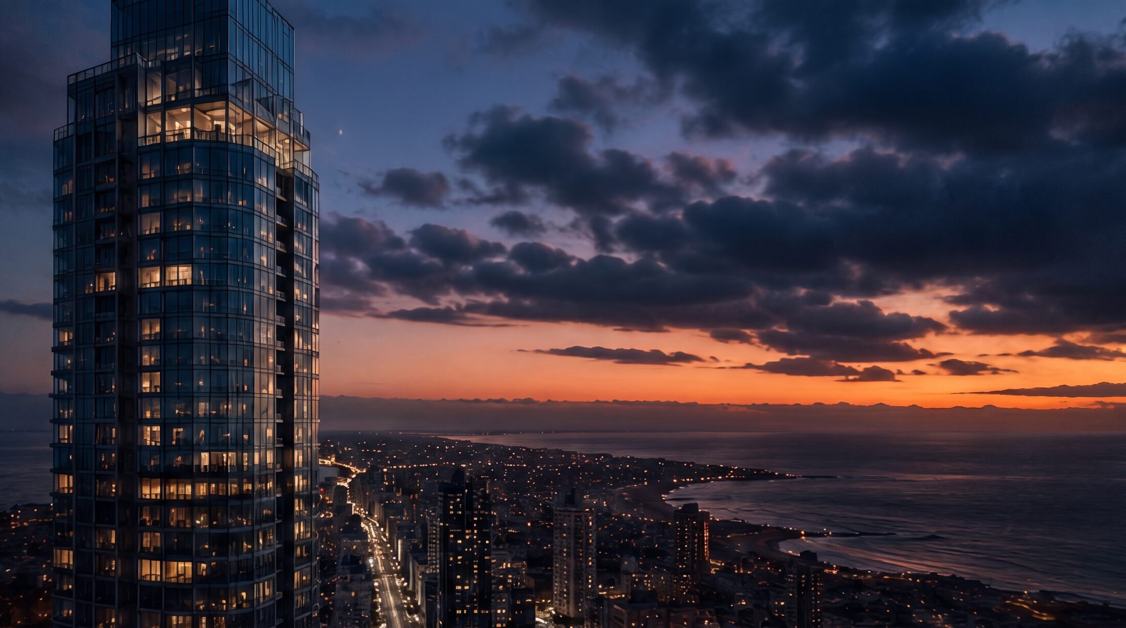 Glass tower at dusk above the Mar del Plata coastline